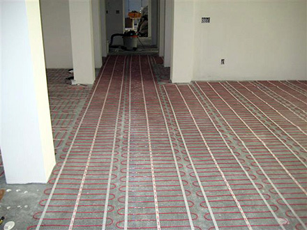 ComfortTile floor heating mats being installed.