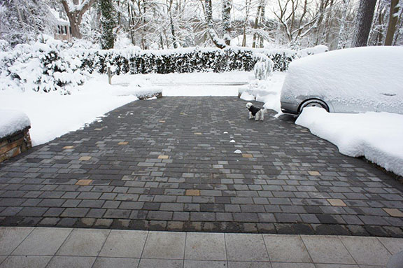 A radiant heated paver driveway after a snowstorm.